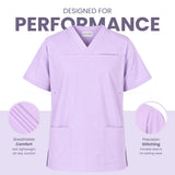 Uk Scrub Suppky A light purple scrub top displayed on a white background with marketing text reading 'DESIGNED FOR PERFORMANCE' and feature callouts for breathability and precision stitching.