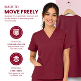 Uk Scrub SUpply A woman wearing burgundy V-neck scrub tops stands against a split white and pale pink background with marketing text and icons about freedom of movement, storage pockets, and care fabric. A second view of the scrub top appears on a hanger behind her.