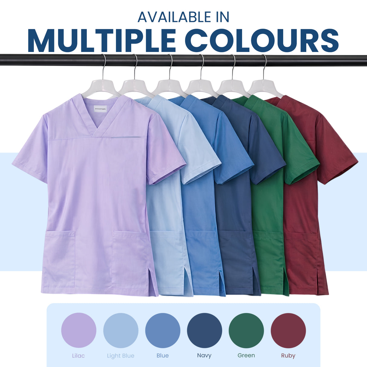 Uk Scrub Supply Six scrub tops in different colors hanging on a rack, with text reading 'AVAILABLE IN MULTIPLE COLOURS' and a color circle label row below showing Lilac, Light Blue, Blue, Navy, Green, and Ruby.