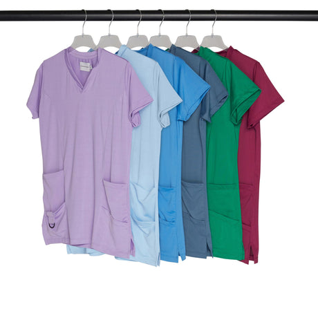 Colorful scrub tops hanging on a rack.