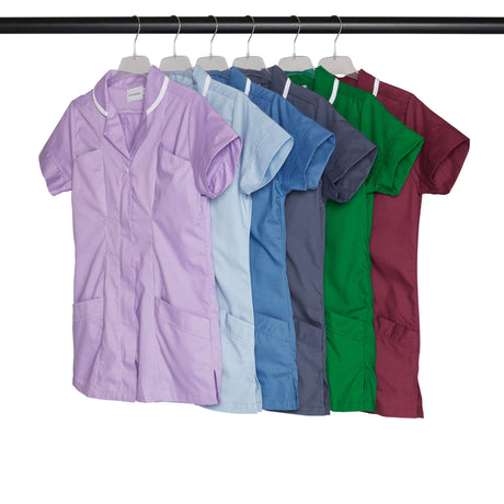 Row of colorful scrub tops hanging on a rack.