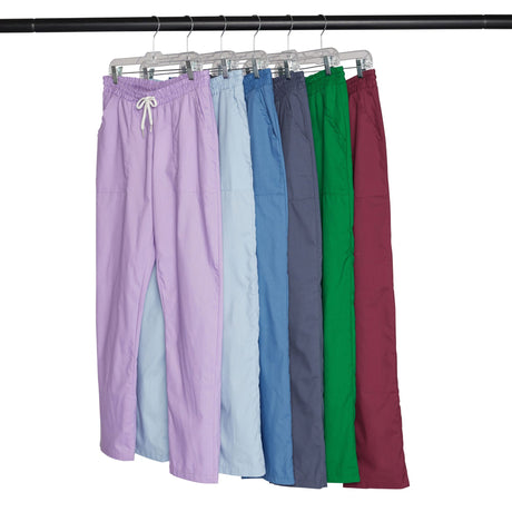Five pairs of pants in different colors on hangers.