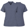 A women's short-sleeve V-neck scrub top shown from both the front and back views. The scrub top is a solid slate blue color with two front patch pockets, one of which has a metal snap button closure.