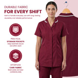 A woman models a burgundy short-sleeve scrub top and matching scrub pants against a light pink background, with a second view of the scrub top on a hanger behind her. Text highlights durable fabric, practical storage pockets, and effortless care fabric Women’s Medical Tunic Nursing & Healthcare Uniform UK scrub tops
scrubs clothing
nursing scrubs
medical uniforms
scrubs for sale
work scrubs
buy medical uniforms
female scrub tops
order scrubs
scrubs to purchase
cheap scrub tops
cotton scrubs uk
scrubs top
cl