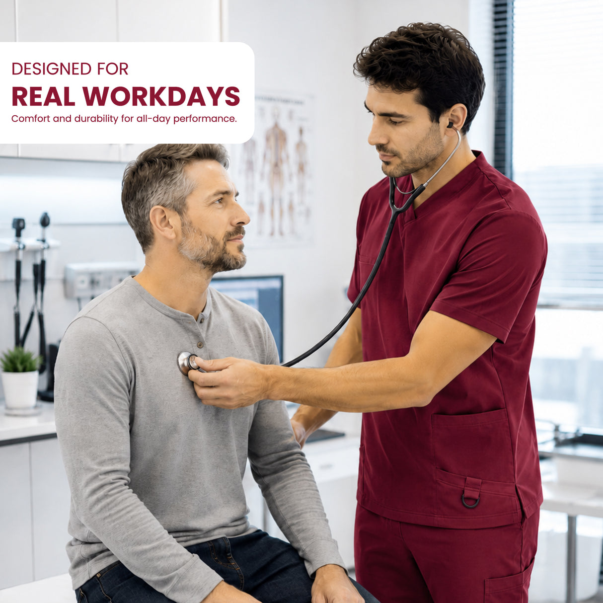 A man in maroon medical scrubs uses a stethoscope on a seated patient in a bright clinic. A white text box in the top left reads 'DESIGNED FOR REAL WORKDAYS' with smaller text below.