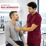 A man in maroon medical scrubs uses a stethoscope on a seated patient in a bright clinic. A white text box in the top left reads 'DESIGNED FOR REAL WORKDAYS' with smaller text below.
